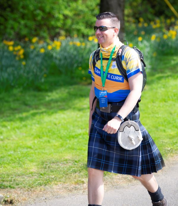 man in kilk walking