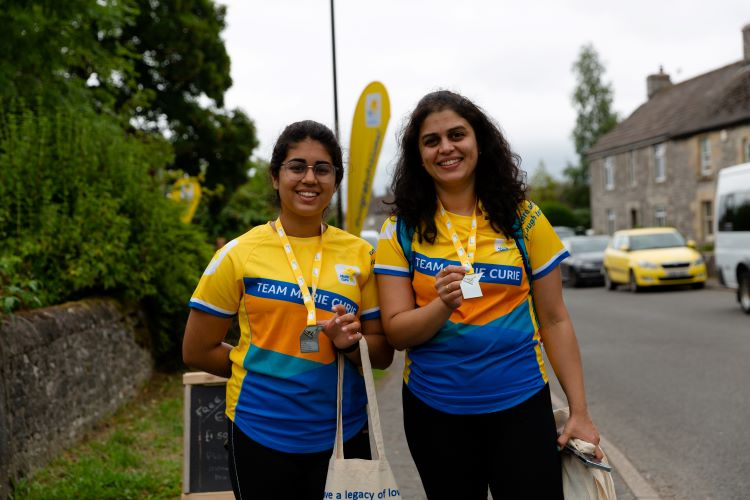 Two trekkers showing off their medals