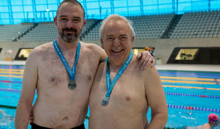 Two smiling men at Swimathon 2018 in support of Marie Curie and CRUK