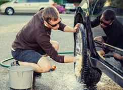 Man washing a car for his fundraising car washing service