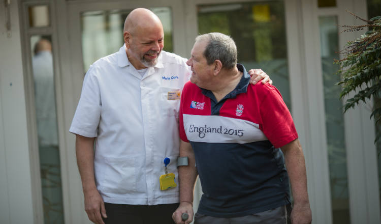 Male nurse supporting a patient at Newcastle hospice